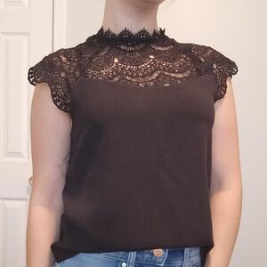 This adorable high neck top features a partial knit design